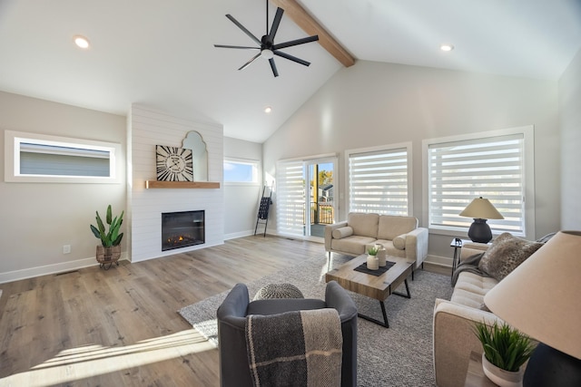 living room with a fireplace, wood finished floors, high vaulted ceiling, beamed ceiling, and baseboards