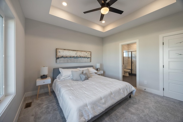 bedroom with baseboards, visible vents, a raised ceiling, and recessed lighting