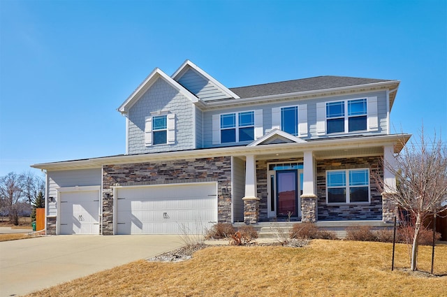 craftsman inspired home with stone siding, covered porch, concrete driveway, and a front yard