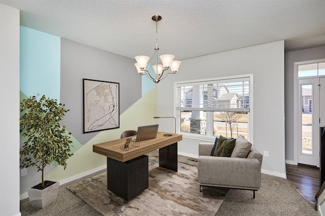 office with a chandelier, a textured ceiling, and baseboards