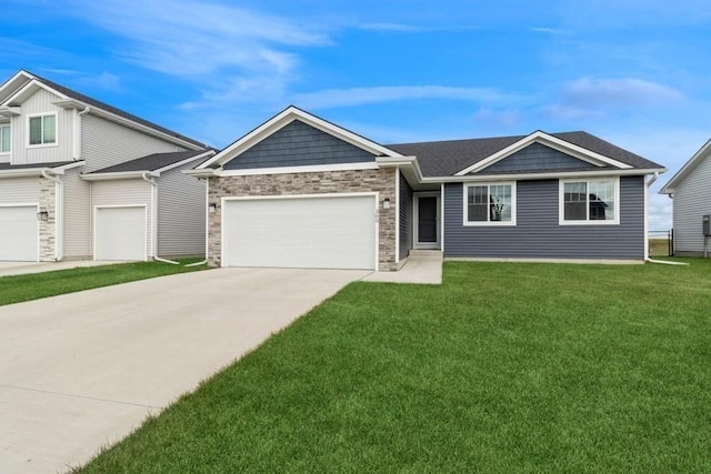 view of front facade featuring driveway, a front lawn, an attached garage, and stone siding