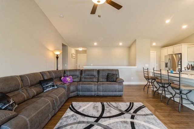 living room with baseboards, dark wood-style floors, ceiling fan, vaulted ceiling, and recessed lighting