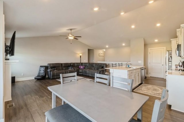 dining area featuring lofted ceiling, dark wood-style floors, visible vents, and recessed lighting