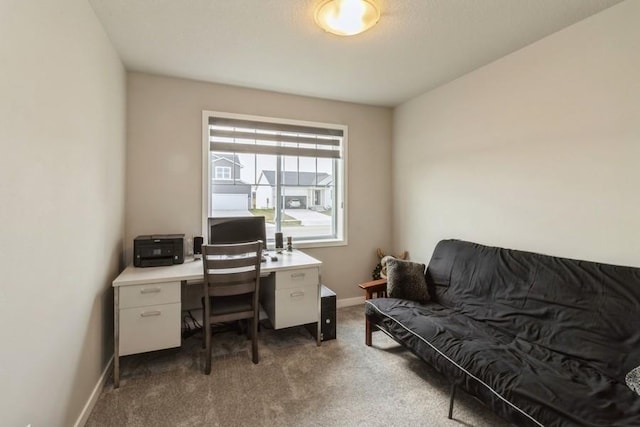 carpeted office featuring baseboards