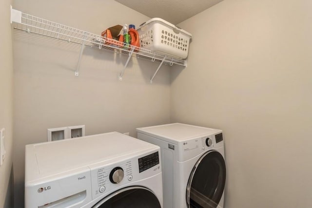 clothes washing area featuring laundry area and washer and dryer