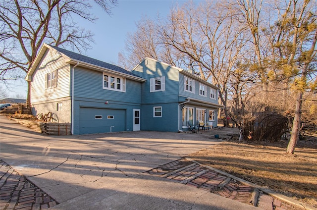 view of front of home featuring an attached garage, concrete driveway, and brick siding