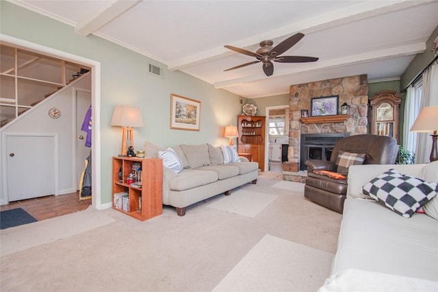 living room with carpet floors, a fireplace, visible vents, ceiling fan, and beamed ceiling