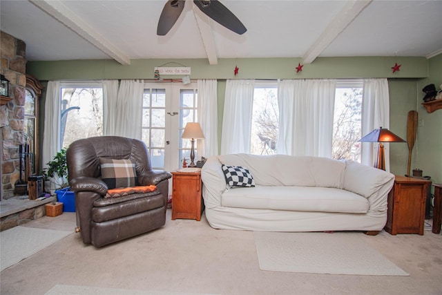 living area with plenty of natural light, carpet, and beam ceiling