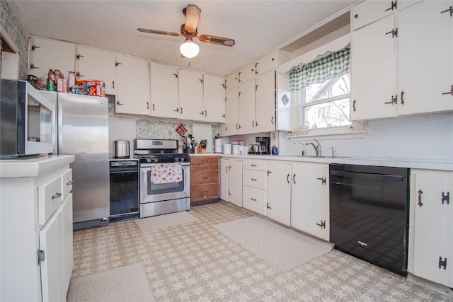 kitchen with light floors, appliances with stainless steel finishes, light countertops, and white cabinetry