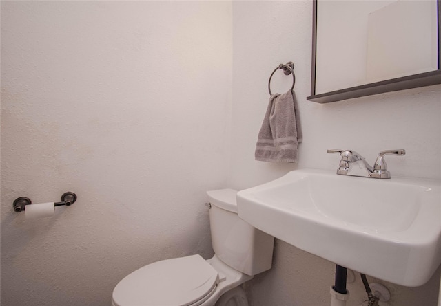 bathroom with toilet and a sink