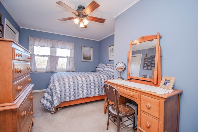 carpeted bedroom featuring baseboards, a ceiling fan, and crown molding