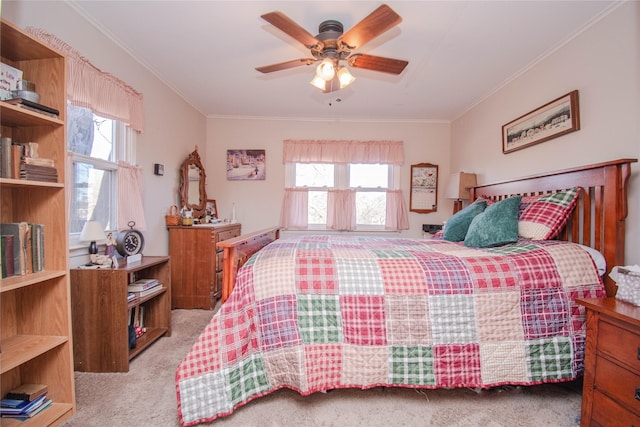 carpeted bedroom featuring ornamental molding, multiple windows, and a ceiling fan