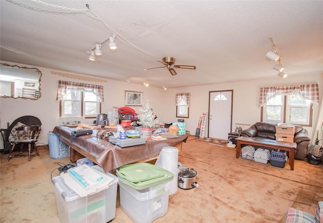 dining room with carpet floors, ceiling fan, and a textured ceiling