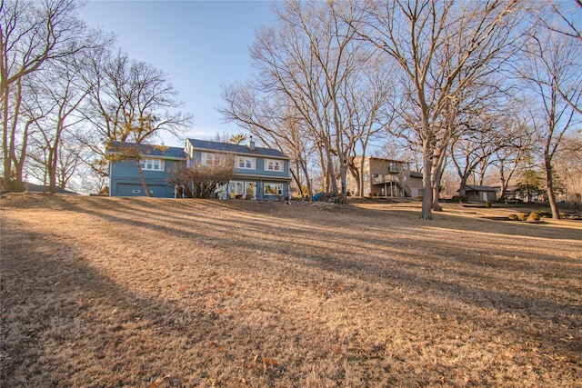 view of front of property featuring stairs and a front yard