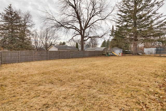 view of yard featuring a playground and a fenced backyard