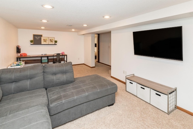 carpeted living area with recessed lighting and baseboards