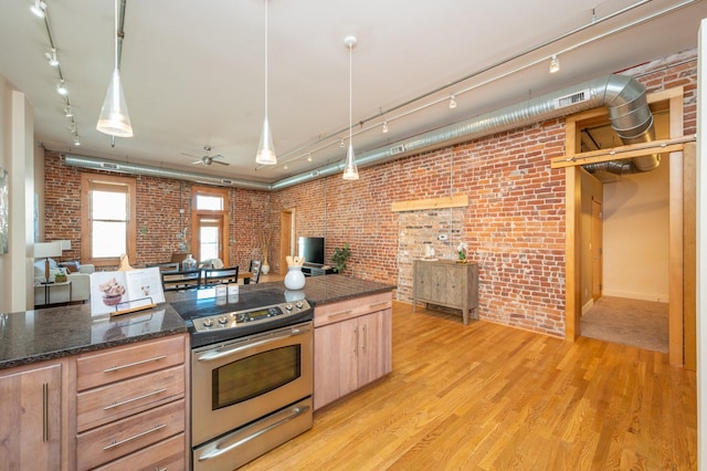 kitchen featuring light wood-type flooring, brick wall, open floor plan, and stainless steel range with electric cooktop