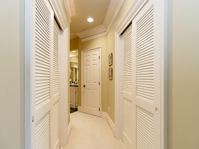 hall featuring recessed lighting, baseboards, ornamental molding, and light colored carpet