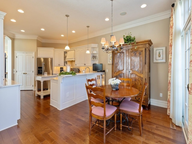 dining room with dark wood-type flooring, crown molding, and baseboards