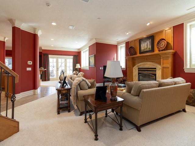 living room with crown molding, recessed lighting, light colored carpet, and a fireplace