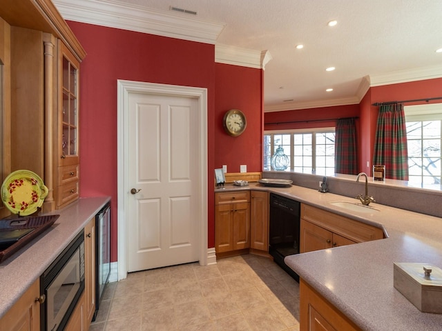 kitchen with a sink, visible vents, black dishwasher, stainless steel microwave, and crown molding