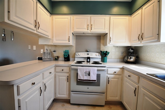 kitchen with white cabinets, light countertops, and white range with electric cooktop