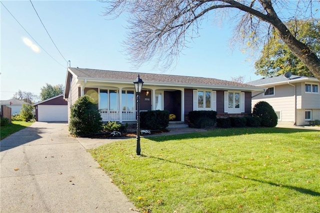 ranch-style house featuring a front yard, an outdoor structure, and a detached garage