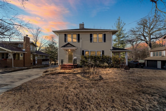 view of front of home featuring a chimney