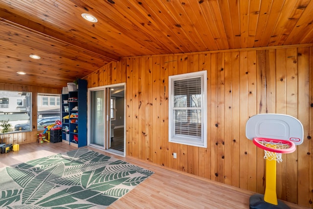 playroom with lofted ceiling, wooden ceiling, wood finished floors, and wooden walls