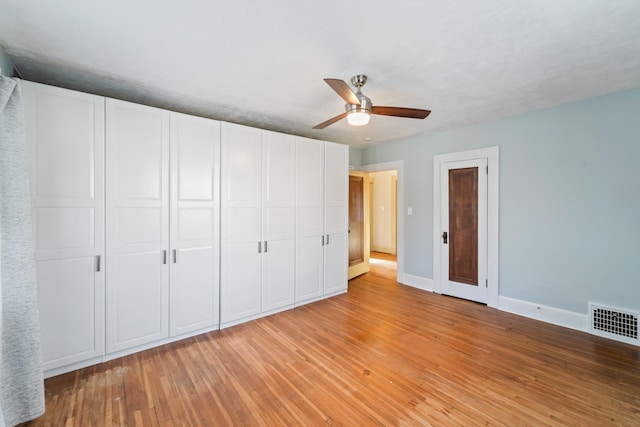 unfurnished bedroom featuring light wood finished floors, baseboards, visible vents, and ceiling fan