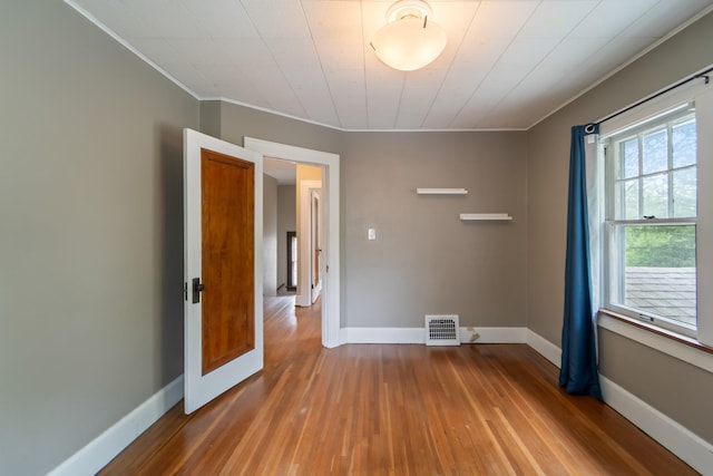 6015 Waterbury Cir, Des Moines, IA 50312 - spare room with crown molding, wood-type flooring, and baseboards