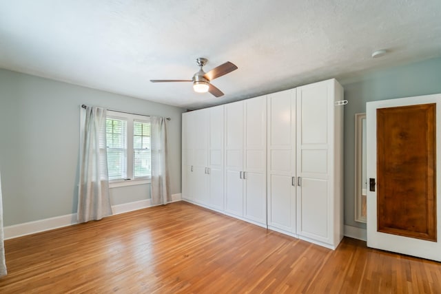 6015 Waterbury Cir, Des Moines, IA 50312 - unfurnished bedroom with light wood-style flooring, baseboards, a closet, and a ceiling fan