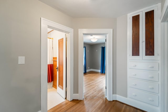 6015 Waterbury Cir, Des Moines, IA 50312 - hallway featuring baseboards and light wood finished floors