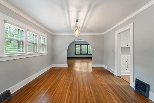 6015 Waterbury Cir, Des Moines, IA 50312 - spare room with arched walkways, ornamental molding, hardwood / wood-style floors, and baseboards