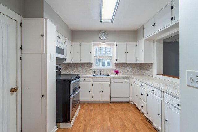 6015 Waterbury Cir, Des Moines, IA 50312 - kitchen with white appliances, decorative backsplash, a sink, and white cabinets