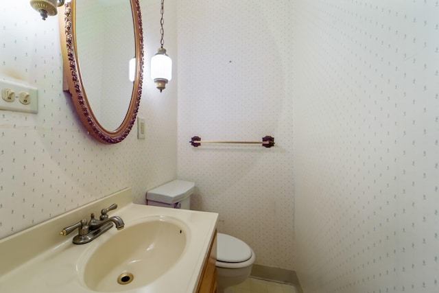 6015 Waterbury Cir, Des Moines, IA 50312 - bathroom with toilet, wallpapered walls, and vanity