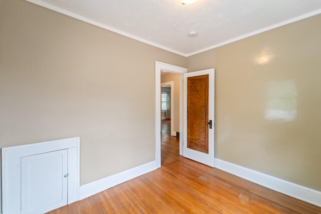 6015 Waterbury Cir, Des Moines, IA 50312 - unfurnished room featuring baseboards, light wood-style flooring, and ornamental molding