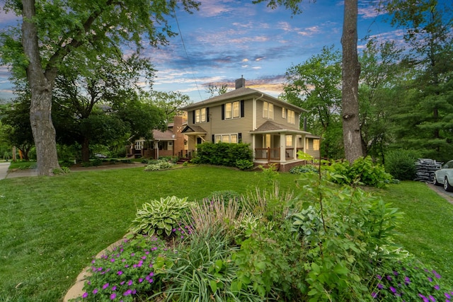 6015 Waterbury Cir, Des Moines, IA 50312 - view of side of home with a chimney, a lawn, and a porch