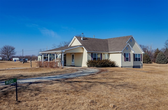 view of front of house featuring a front yard and roof with shingles