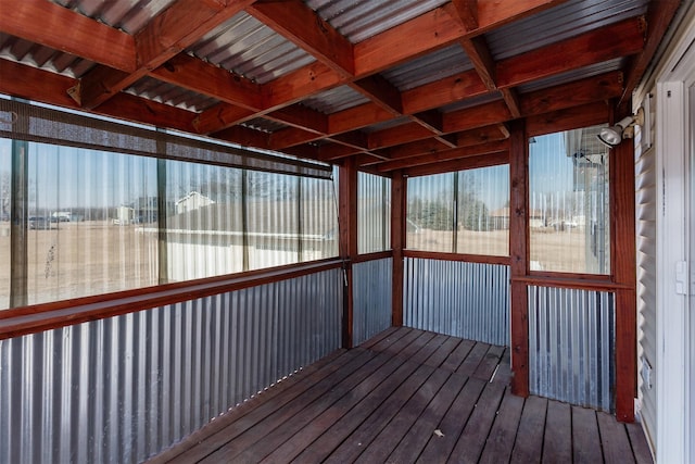 unfurnished sunroom featuring beamed ceiling and coffered ceiling