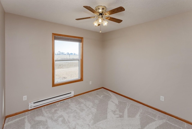 empty room featuring baseboards, a ceiling fan, carpet, baseboard heating, and a textured ceiling