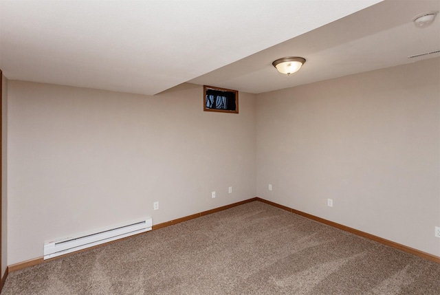 carpeted spare room featuring baseboard heating, visible vents, and baseboards