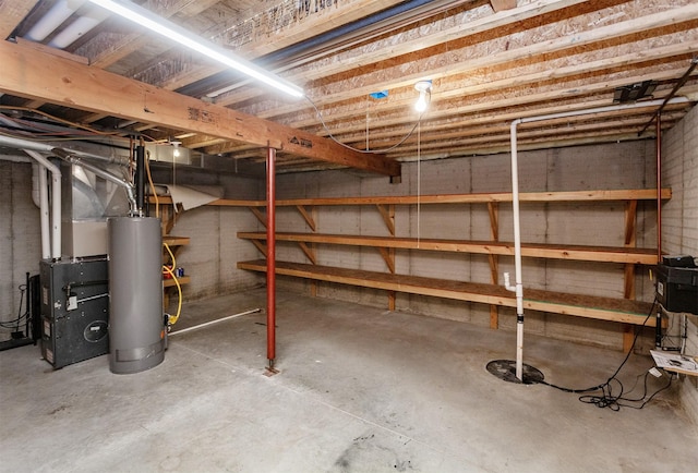 unfinished below grade area featuring water heater and heating unit