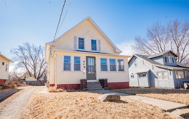 bungalow-style house with entry steps and driveway