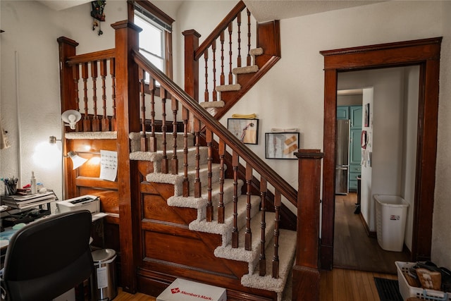 stairway featuring wood finished floors