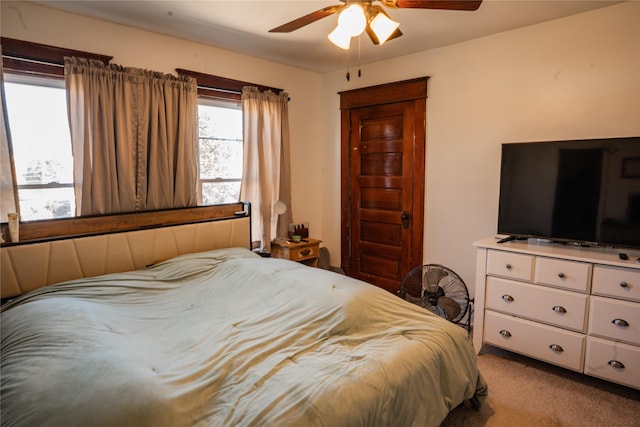 bedroom with ceiling fan and carpet floors