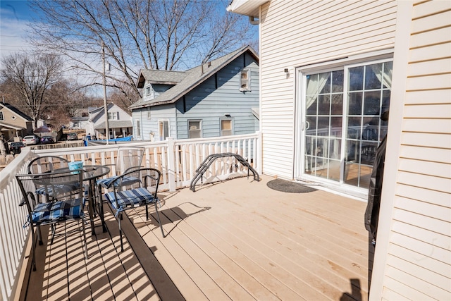 deck with a residential view and outdoor dining space