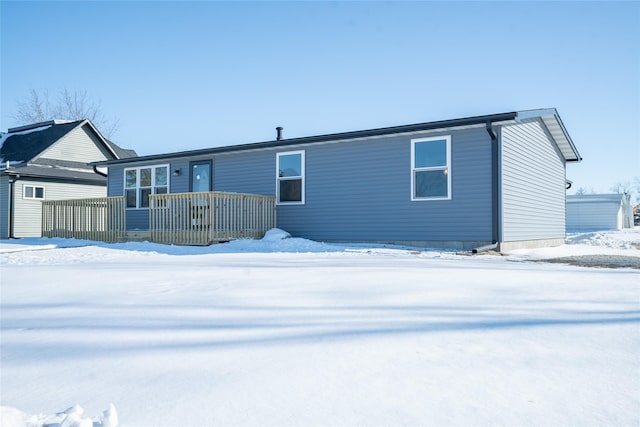 view of snow covered rear of property