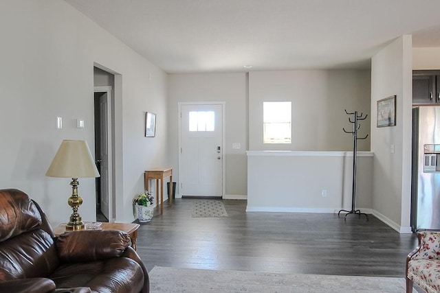 foyer featuring dark wood-style floors and baseboards