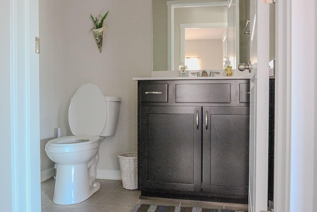 half bath featuring toilet, baseboards, vanity, and tile patterned floors